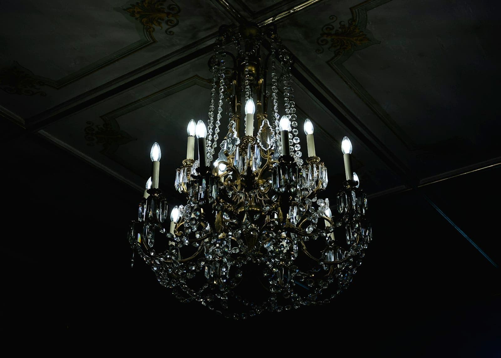 Crystal chandelier glowing in a dark room