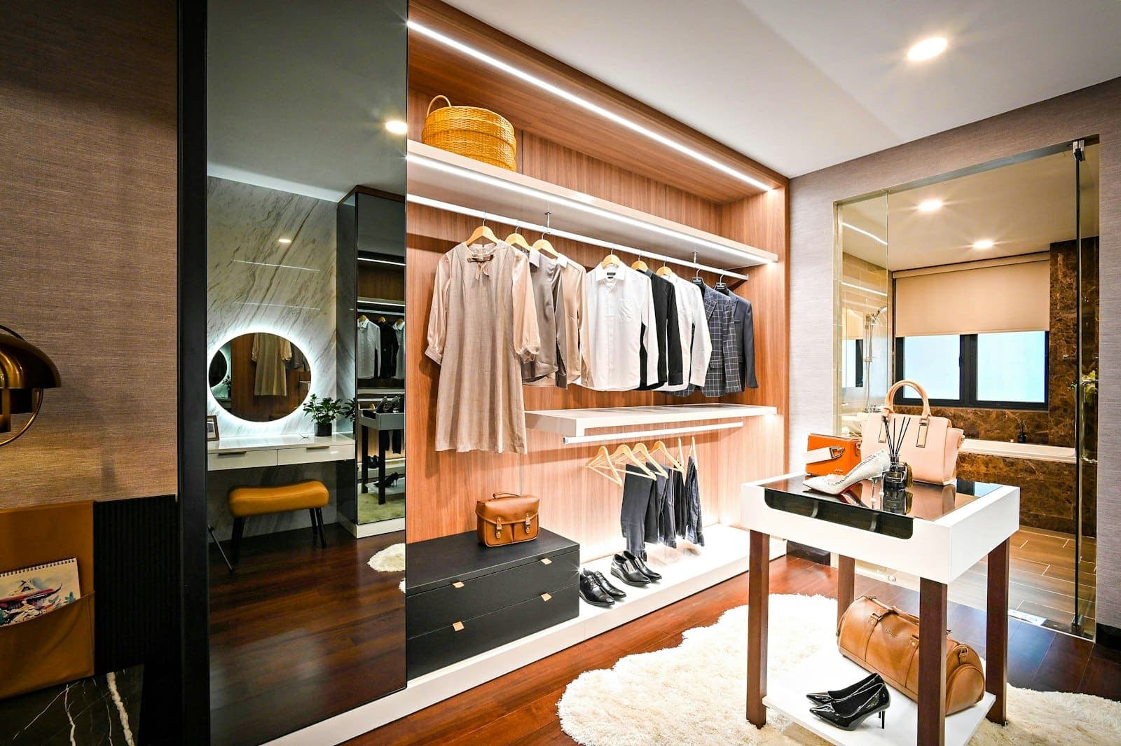 Walk-in wardrobe with LED strips built into the shelves, hanging rails and a backlit mirror