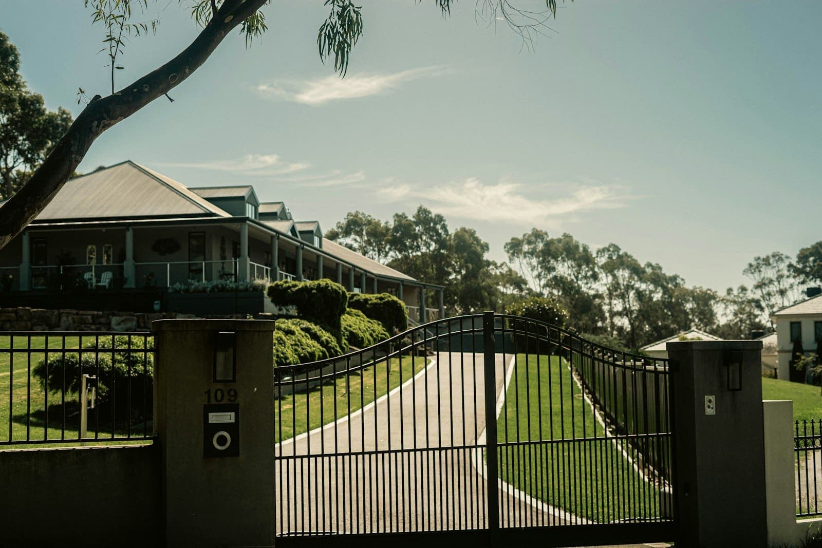Automatic gate at the entrance of a driveway leading to a house